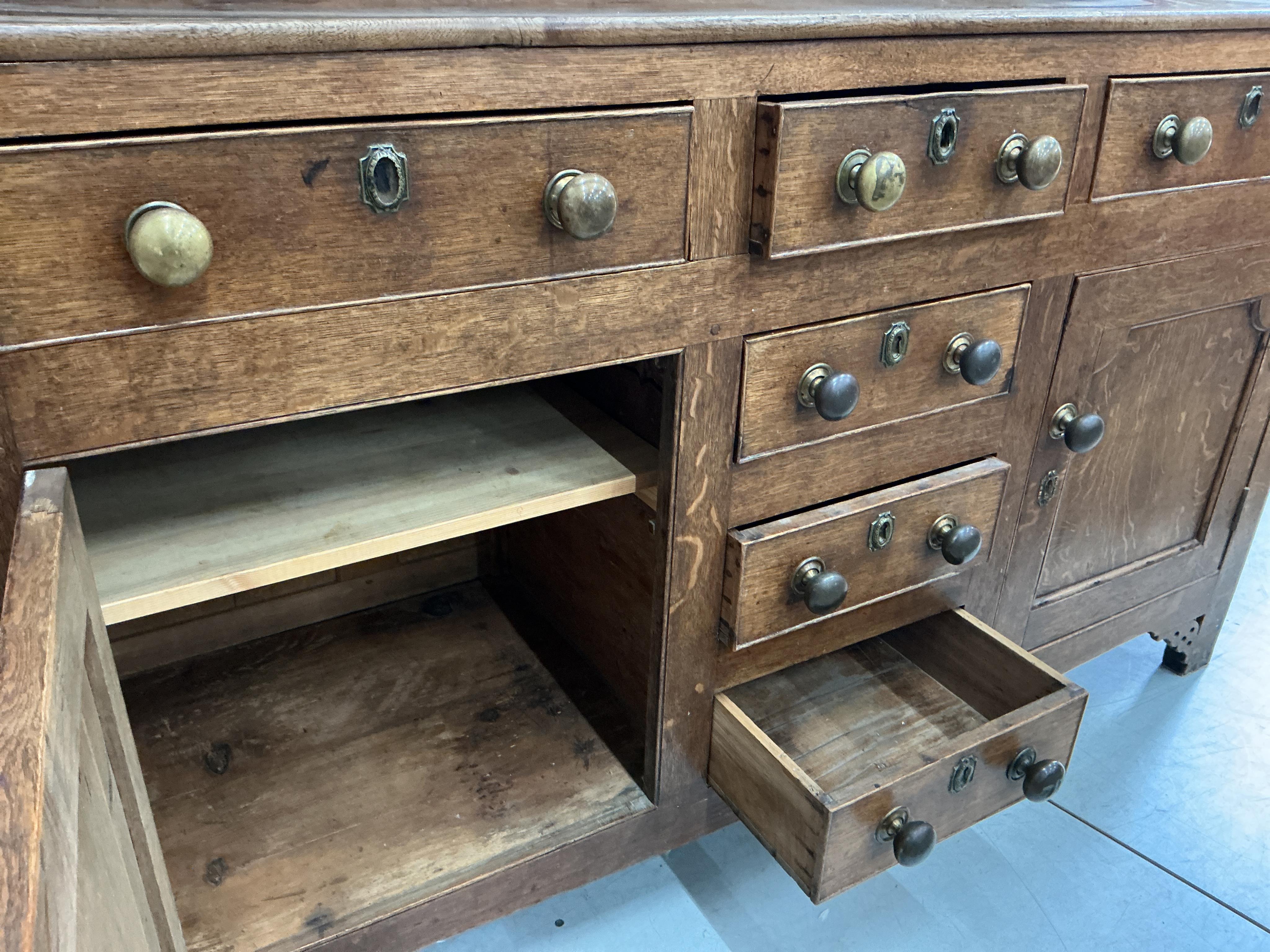 An early 19th century oak dresser with boarded rack, width 153cm, depth 48cm, height 204cm